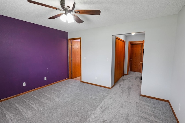 102 Jackson St, Pella, IA 50219 - unfurnished room featuring ceiling fan, carpet flooring, baseboards, and a textured ceiling