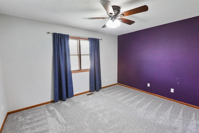 102 Jackson St, Pella, IA 50219 - carpeted spare room with a ceiling fan, baseboards, and a textured ceiling