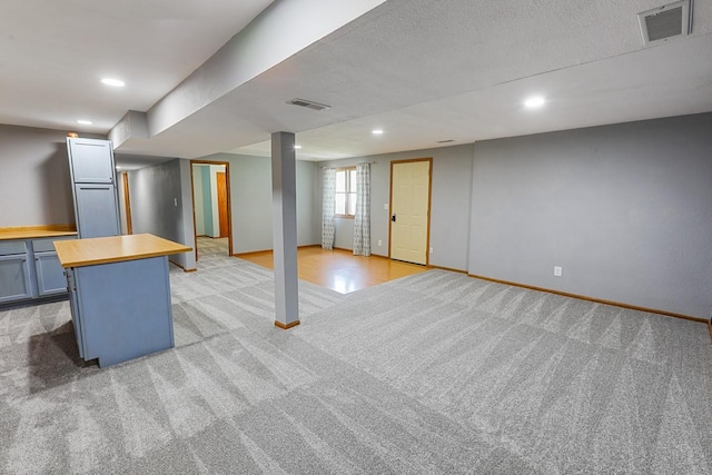 102 Jackson St, Pella, IA 50219 - below grade area featuring light carpet, recessed lighting, and baseboards