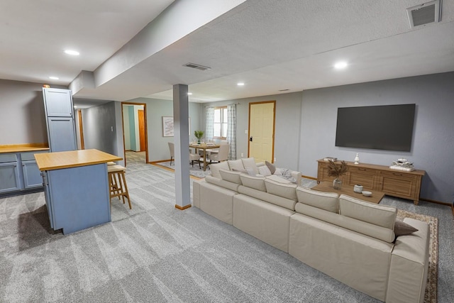 102 Jackson St, Pella, IA 50219 - living room with light carpet, recessed lighting, and baseboards