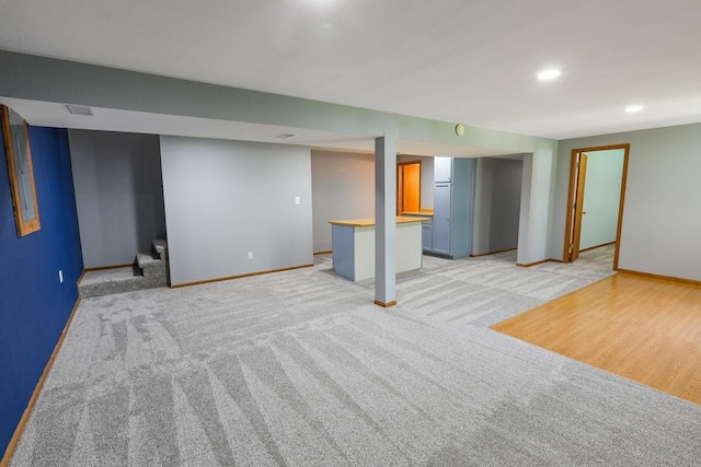 102 Jackson St, Pella, IA 50219 - finished basement with baseboards, light carpet, and recessed lighting