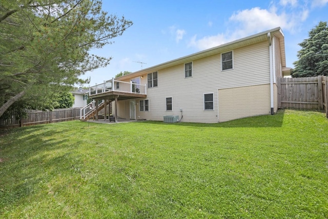 102 Jackson St, Pella, IA 50219 - back of property with stairs, a deck, central AC, and a patio