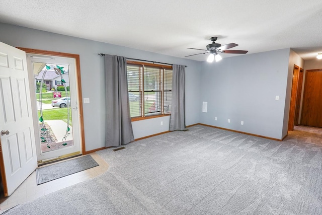 102 Jackson St, Pella, IA 50219 - carpeted entrance foyer featuring healthy amount of natural light, ceiling fan, and baseboards