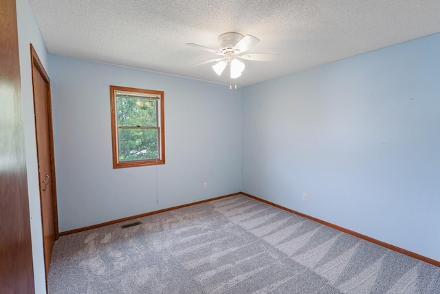 102 Jackson St, Pella, IA 50219 - empty room with carpet flooring, ceiling fan, a textured ceiling, and baseboards
