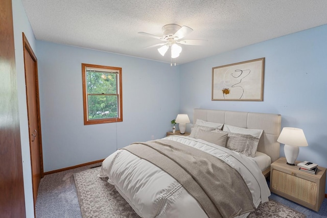 102 Jackson St, Pella, IA 50219 - bedroom featuring carpet flooring, a textured ceiling, baseboards, a closet, and ceiling fan