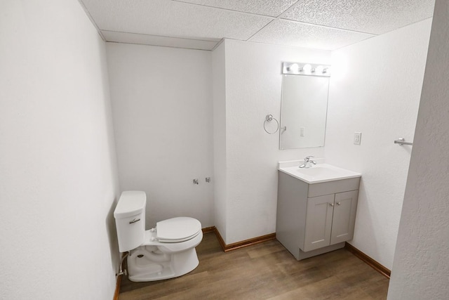 102 Jackson St, Pella, IA 50219 - half bathroom featuring toilet, wood finished floors, and vanity