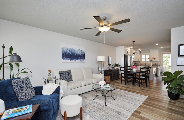 134 Aspen Dr, Norwalk, IA 50211 - living room featuring a chandelier, wood finished floors, a ceiling fan, and recessed lighting