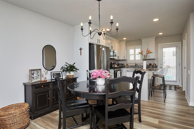 134 Aspen Dr, Norwalk, IA 50211 - dining space featuring a chandelier, light wood-type flooring, and recessed lighting