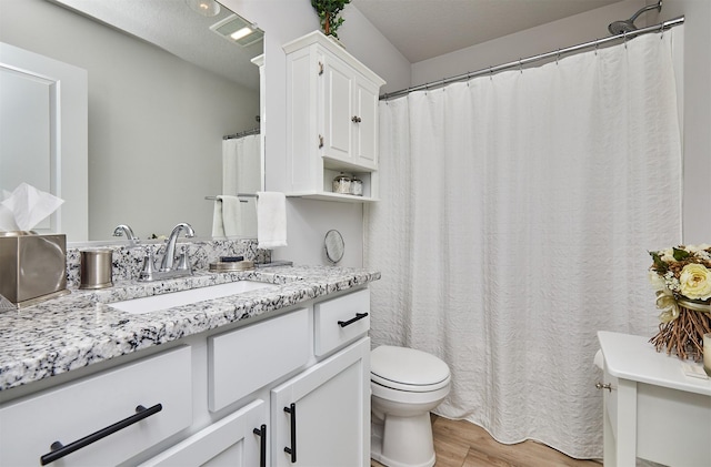 134 Aspen Dr, Norwalk, IA 50211 - bathroom with toilet, wood finished floors, and vanity