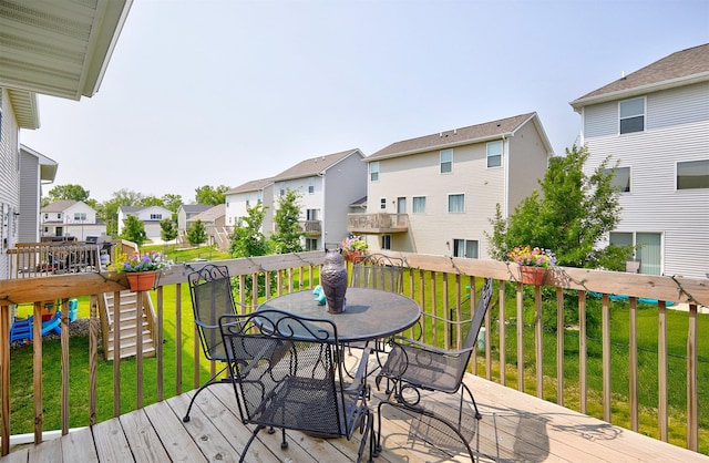 134 Aspen Dr, Norwalk, IA 50211 - wooden deck with a residential view, outdoor dining area, a yard, and a playground
