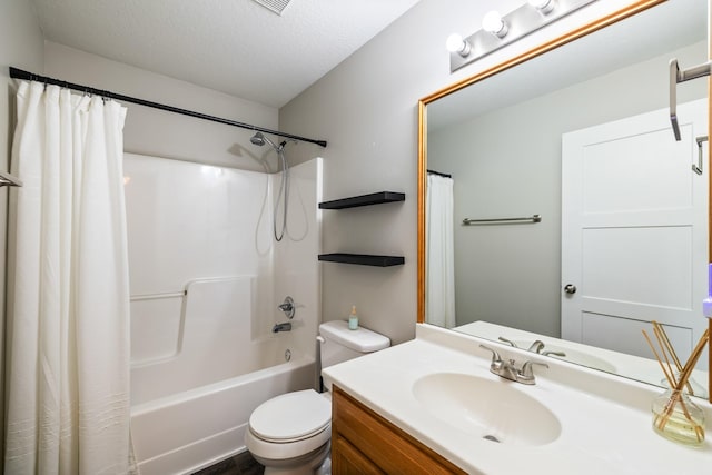 3605 Village Run Dr, Des Moines, IA 50317 - bathroom featuring vanity, shower / tub combo with curtain, toilet, and a textured ceiling