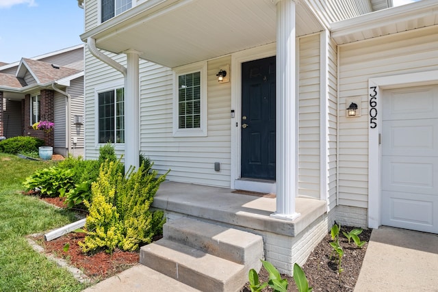 3605 Village Run Dr, Des Moines, IA 50317 - doorway to property featuring a garage and covered porch