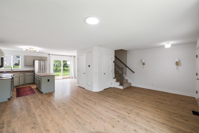 3605 Village Run Dr, Des Moines, IA 50317 - kitchen featuring gray cabinets, light wood-style flooring, and plenty of natural light