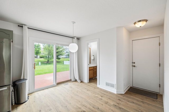 3605 Village Run Dr, Des Moines, IA 50317 - unfurnished dining area featuring light wood-style floors and baseboards