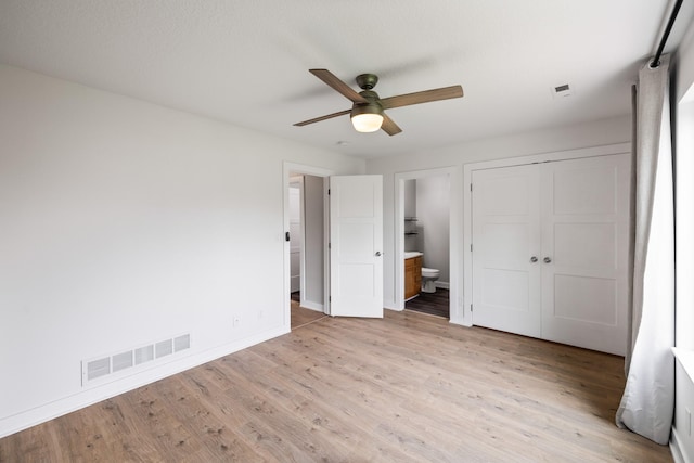 3605 Village Run Dr, Des Moines, IA 50317 - unfurnished bedroom with light wood-type flooring, baseboards, ensuite bath, and a closet