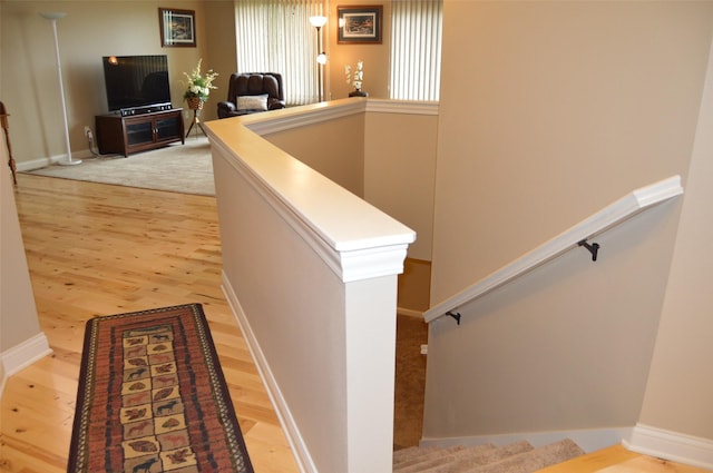 6029 Meacham Dr, Pleasant Hill, IA 50327 - stairway featuring wood finished floors and baseboards