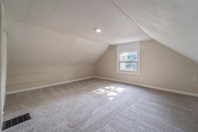 2336 E 13th St, Des Moines, IA 50316 - bonus room with carpet flooring, baseboards, and lofted ceiling