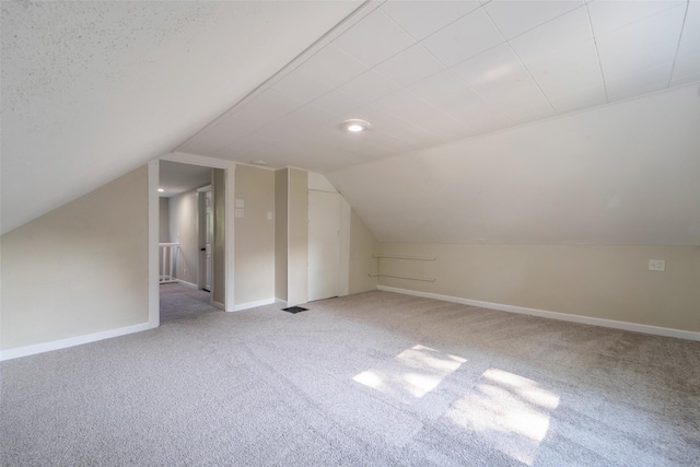2336 E 13th St, Des Moines, IA 50316 - bonus room with carpet, vaulted ceiling, and baseboards