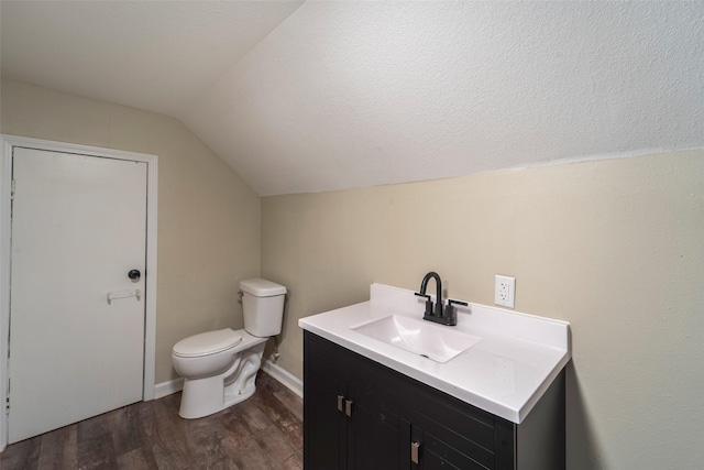 2336 E 13th St, Des Moines, IA 50316 - bathroom with lofted ceiling, wood finished floors, vanity, and toilet