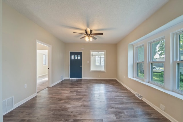 2336 E 13th St, Des Moines, IA 50316 - foyer entrance featuring a ceiling fan, dark wood-style floors, a textured ceiling, and baseboards