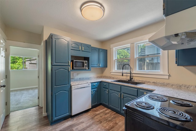 2336 E 13th St, Des Moines, IA 50316 - kitchen with white dishwasher, black / electric stove, a sink, stainless steel microwave, and range hood
