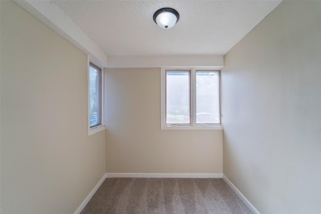 2336 E 13th St, Des Moines, IA 50316 - carpeted spare room with baseboards and a textured ceiling