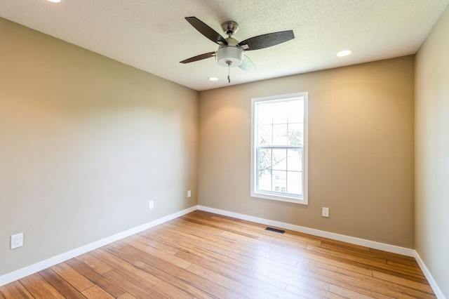 2405 81st Cir, Urbandale, IA 50322 - spare room with a ceiling fan, light wood-style flooring, and recessed lighting