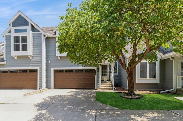 2405 81st Cir, Urbandale, IA 50322 - view of property hidden behind natural elements with concrete driveway and an attached garage