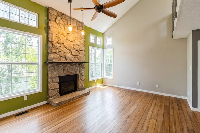 2405 81st Cir, Urbandale, IA 50322 - unfurnished living room with high vaulted ceiling, ceiling fan, healthy amount of natural light, and wood-type flooring
