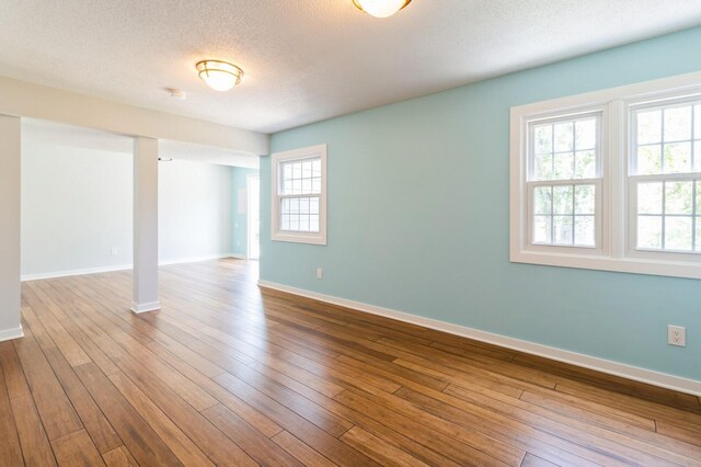 2405 81st Cir, Urbandale, IA 50322 - basement featuring a textured ceiling and dark wood-type flooring