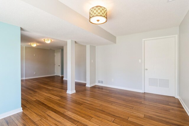 2405 81st Cir, Urbandale, IA 50322 - spare room with wood-type flooring and baseboards
