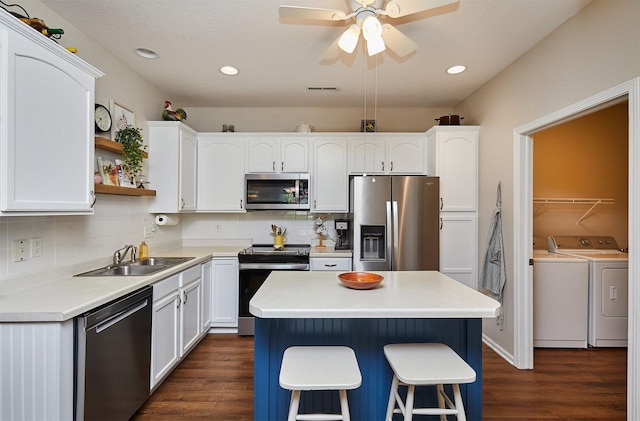 280 S 79th St Unit 1302, West Des Moines, IA 50266 - kitchen with stainless steel appliances, separate washer and dryer, dark wood-type flooring, a sink, and ceiling fan