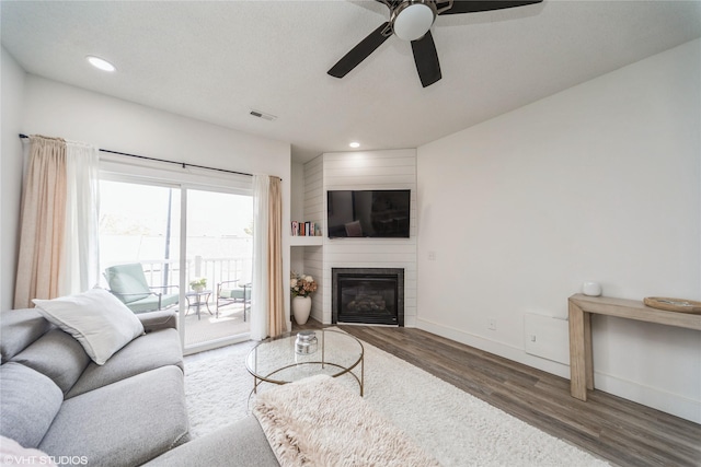 8601 Westown Pkwy Unit 21207, West Des Moines, IA 50266 - living room featuring wood finished floors, a ceiling fan, recessed lighting, baseboards, and a large fireplace