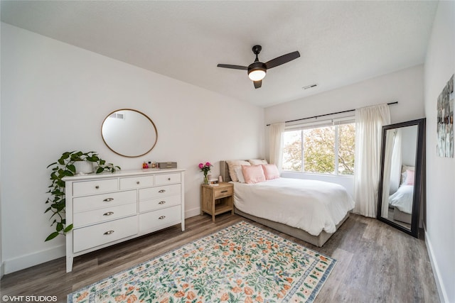 8601 Westown Pkwy Unit 21207, West Des Moines, IA 50266 - bedroom with wood finished floors, baseboards, and a ceiling fan