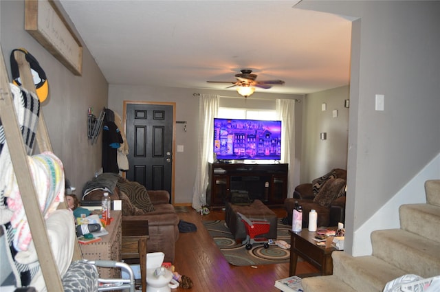104 Walnut Dr NW, Bondurant, IA 50035 - living area featuring wood finished floors, ceiling fan, stairs, and baseboards