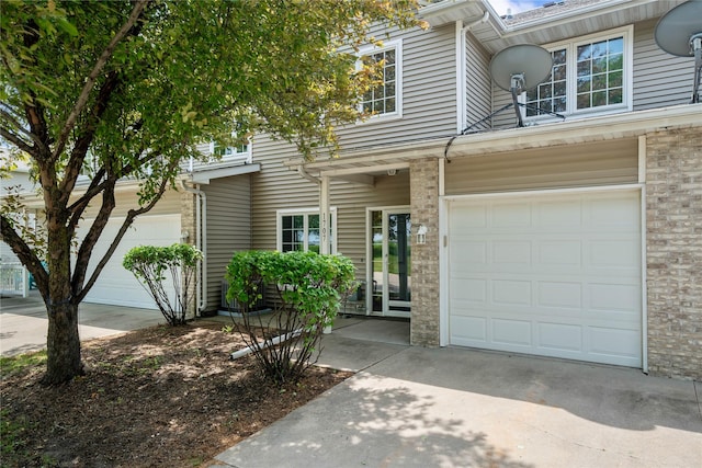 1117 S 52nd St Unit 1707, West Des Moines, IA 50265 - view of front of property with concrete driveway and a garage
