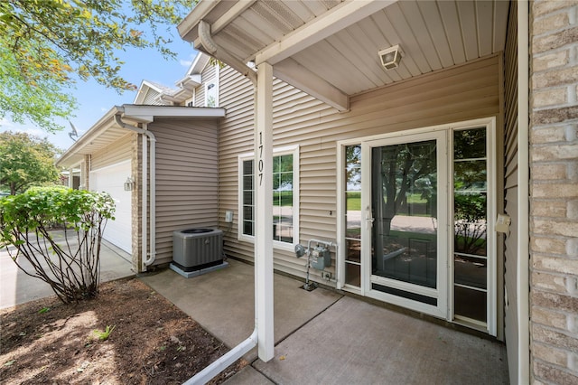 1117 S 52nd St Unit 1707, West Des Moines, IA 50265 - view of patio featuring cooling unit and a garage