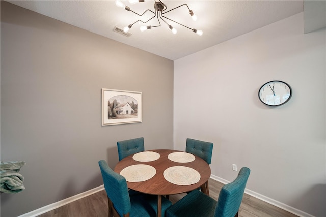 1117 S 52nd St Unit 1707, West Des Moines, IA 50265 - dining space with a chandelier, wood finished floors, and baseboards