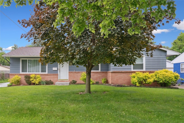 2901 E 40th Ct, Des Moines, IA 50317 - view of property hidden behind natural elements featuring brick siding, a front yard, and entry steps
