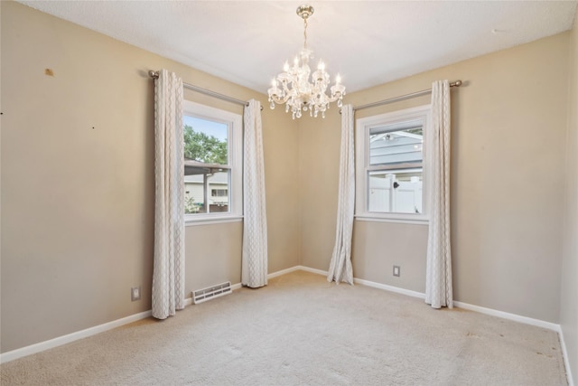 2901 E 40th Ct, Des Moines, IA 50317 - carpeted empty room with a chandelier and baseboards