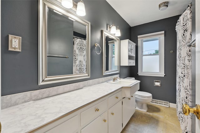 2901 E 40th Ct, Des Moines, IA 50317 - bathroom with toilet, vanity, and baseboards