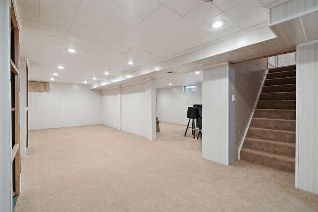 2901 E 40th Ct, Des Moines, IA 50317 - finished basement featuring light carpet, stairs, and recessed lighting