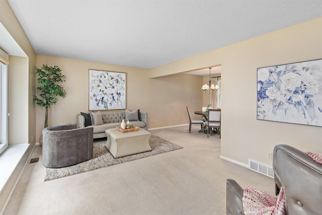 3510 Wolcott Ave, Des Moines, IA 50321 - living area featuring carpet, a chandelier, and baseboards