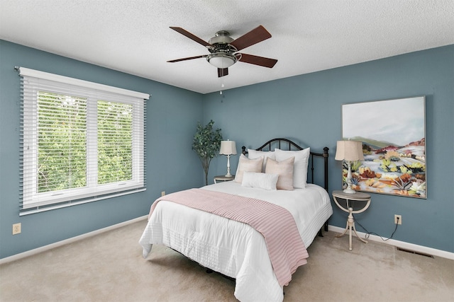 3510 Wolcott Ave, Des Moines, IA 50321 - carpeted bedroom featuring baseboards, a ceiling fan, and a textured ceiling