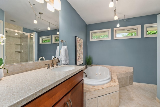 3510 Wolcott Ave, Des Moines, IA 50321 - full bath featuring a shower stall, a jetted tub, vanity, tile patterned floors, and rail lighting