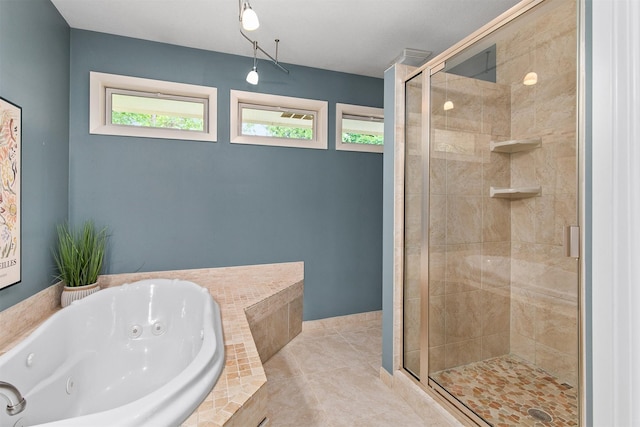 3510 Wolcott Ave, Des Moines, IA 50321 - bathroom featuring a tub with jets, a shower stall, and tile patterned flooring