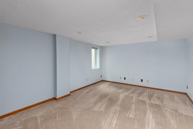 3510 Wolcott Ave, Des Moines, IA 50321 - empty room with a textured ceiling, light carpet, and baseboards