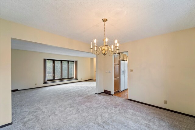 1495 Rio Valley Dr, Clive, IA 50325 - unfurnished room with a chandelier, light carpet, and baseboards