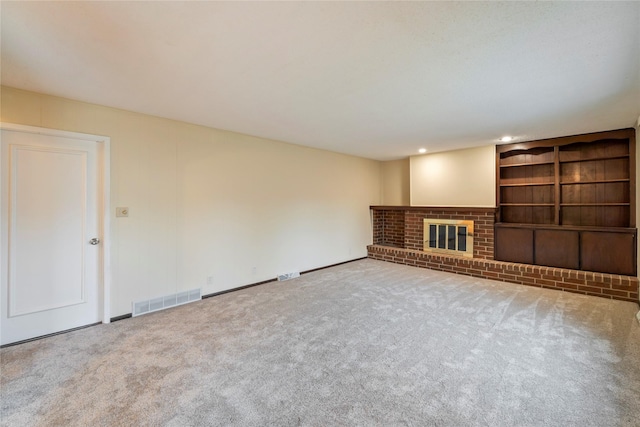 1495 Rio Valley Dr, Clive, IA 50325 - unfurnished living room featuring carpet floors, a fireplace, recessed lighting, built in shelves, and baseboards