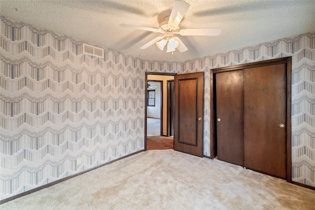 1495 Rio Valley Dr, Clive, IA 50325 - unfurnished bedroom with carpet floors, a textured ceiling, and ceiling fan